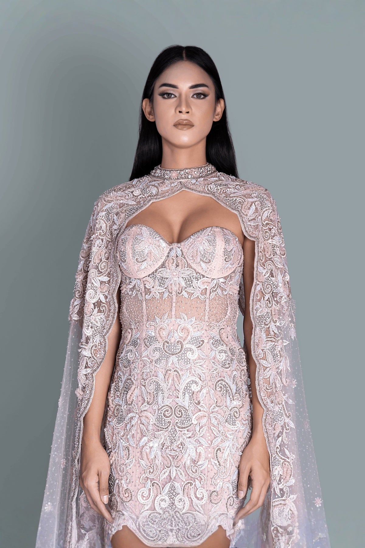 Gown with a dramatic cape and intricate embroidery in a beautiful pattern - Front