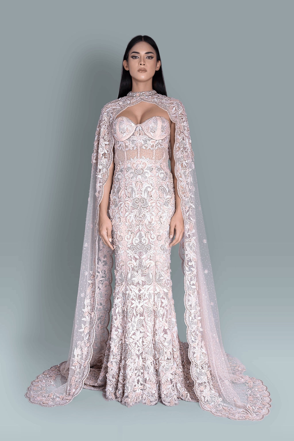 Gown with a dramatic cape and intricate embroidery in a beautiful pattern - Close-up