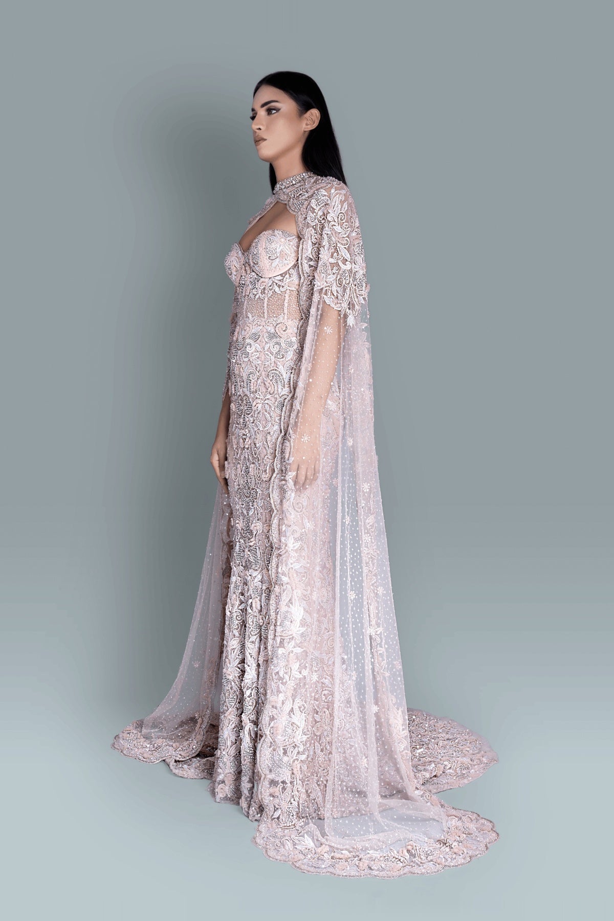 Gown with a dramatic cape and intricate embroidery in a beautiful pattern - Side
