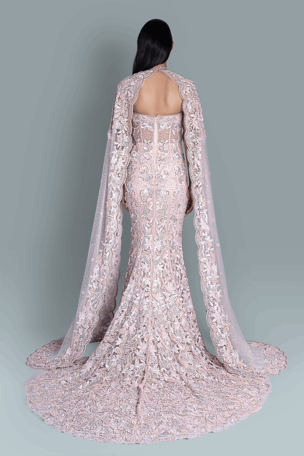 Gown with a dramatic cape and intricate embroidery in a beautiful pattern - Back