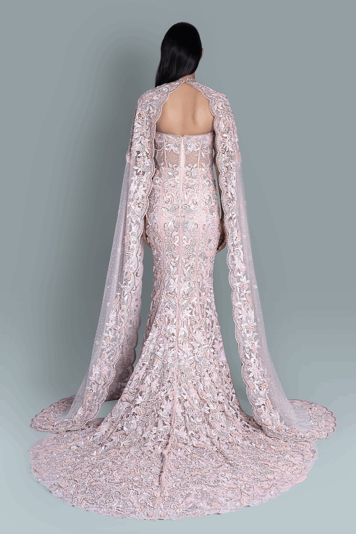 Gown with a dramatic cape and intricate embroidery in a beautiful pattern - Back