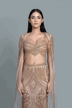 Gown with a dramatic cape and intricate embroidery in a beautiful pattern - Close-up
