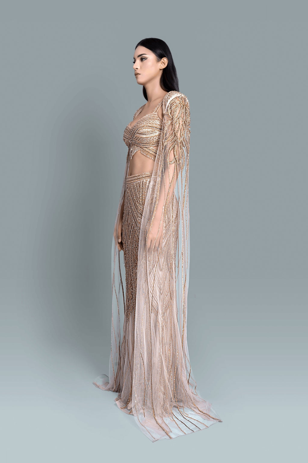 Gown with a dramatic cape and intricate embroidery in a beautiful pattern - Side